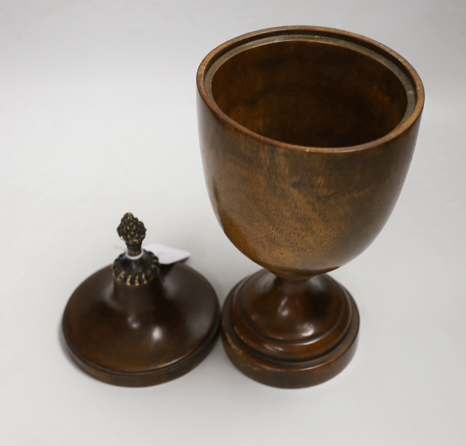 A 19th century turned mahogany urn and cover, 33cm